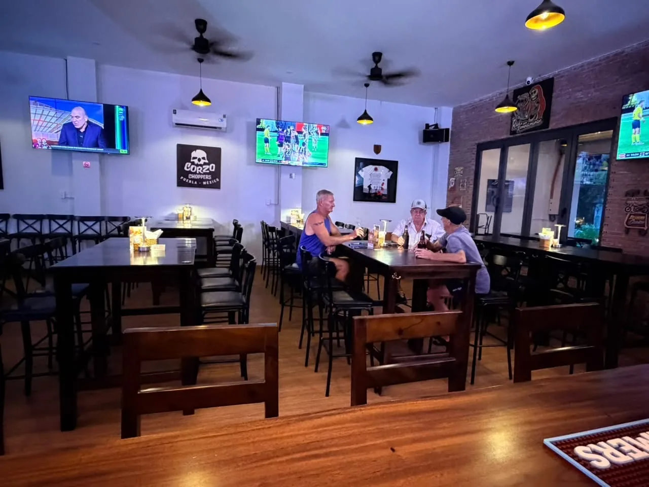 Inside Ironworks with tables and sports screens